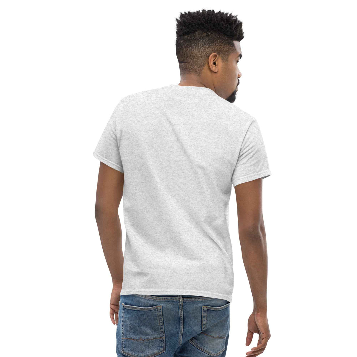 Ash unisex classic tee by Cranston Bean Mariner, worn by a male studio model with rear-view leaning looking right on camera