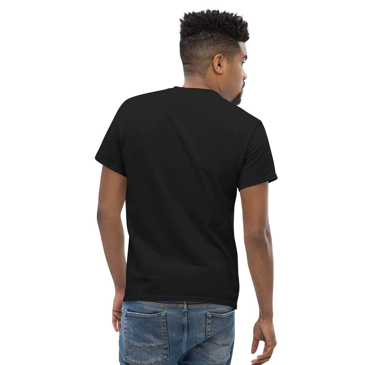 Black unisex classic tee: with a three-quarter back view on male model, paired with blue jeans against studio background