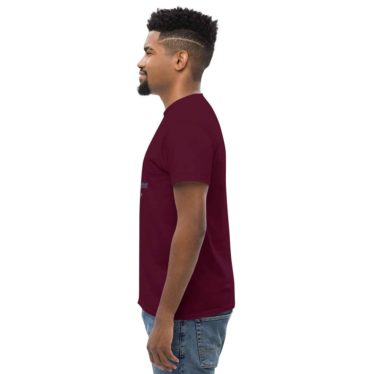 Maroon unisex classic tee: side profile view on a male model standing and facing left, against a clean studio background