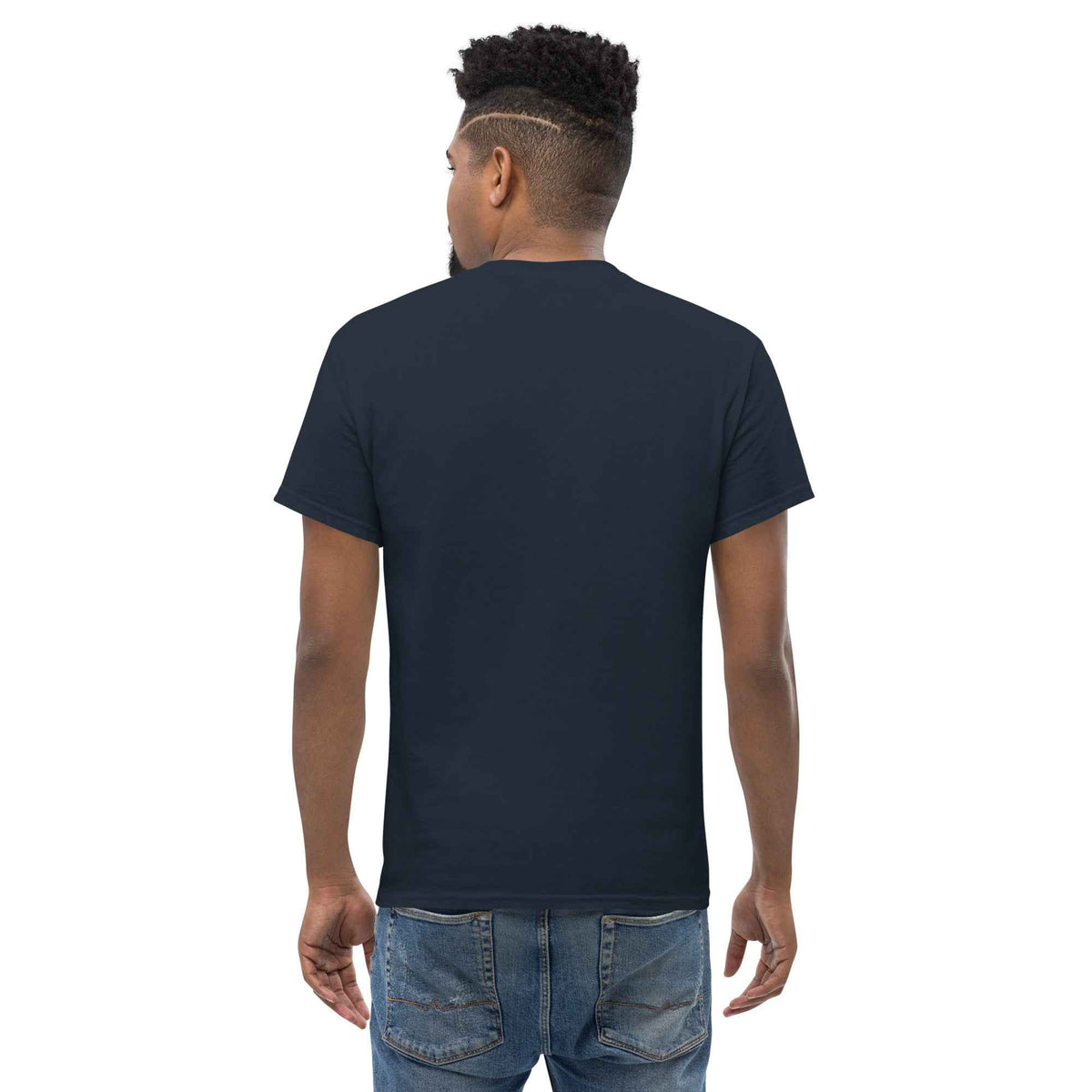 Navy blue unisex classic tee: with a rear view on a male model, styled and paired with blue jeans against a studio backdrop