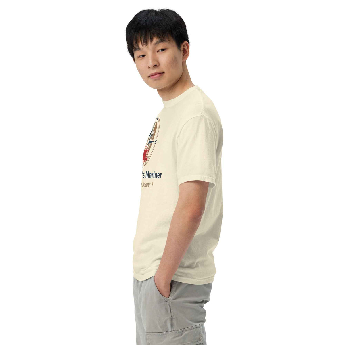 Unisex Garment-Dyed Heavyweight Ivory T-shirt by Cranston Bean Mariner. Model with hands in pocket face left, looking direct